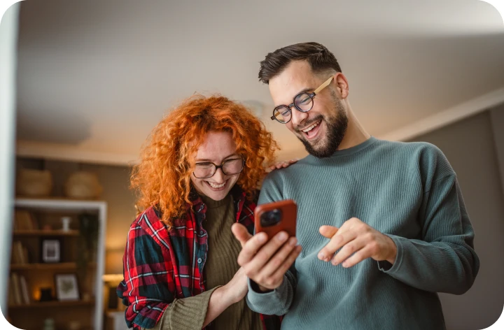 Couple at a table looking at a tablet