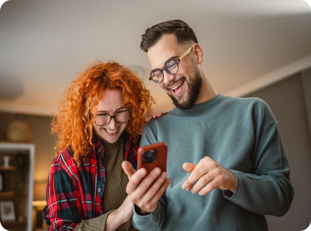Woman looking at her phone in a kitchen
